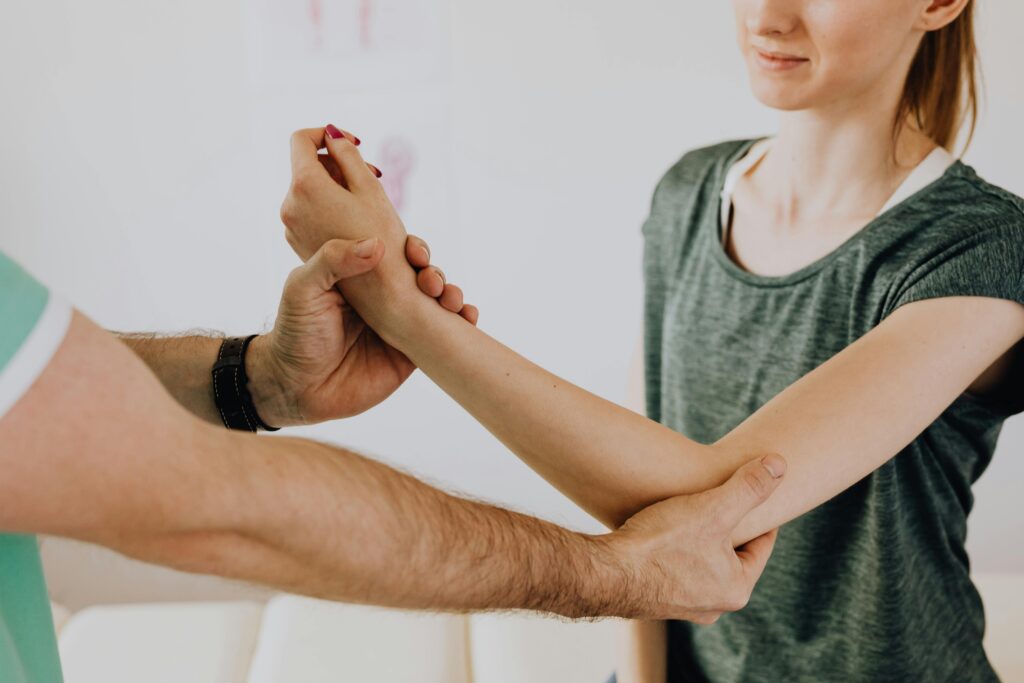 pexels-photo-4506071-4506071 Image of a physiotherapy session focusing on arm movement and manual adjustment.