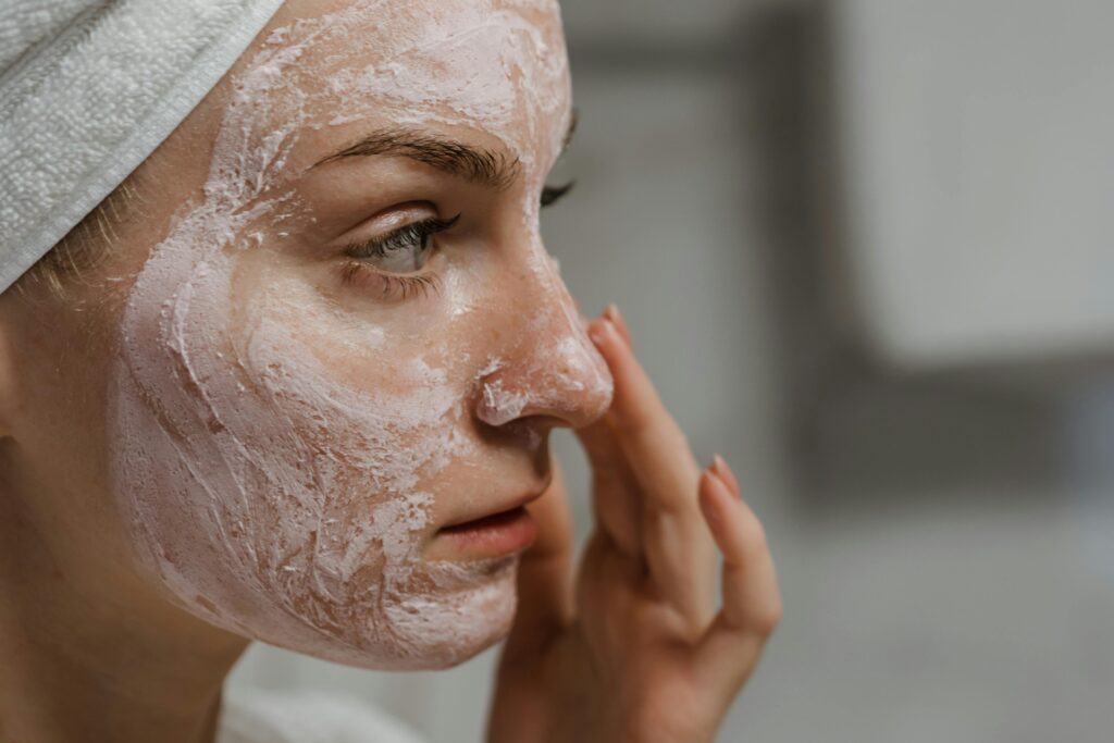pexels-photo-5927811-5927811 Close-up of a woman applying facial cream as part of her skincare routine, enhancing skin health.